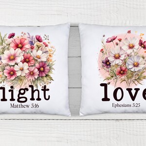 May include: Two white pillowcases with floral designs and inspirational quotes. The left pillowcase features a bouquet of pink and white flowers with the text "light" and "Matthew 5:16". The right pillowcase features a bouquet of pink and white flowers in a circle with the text "love" and "Ephesians 5:25".