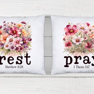 May include: Two white pillow covers with floral designs and the words "rest" and "pray" with bible verses. The floral design is pink, white, and yellow.