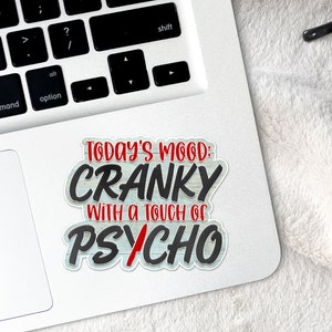 May include: A white sticker with a black and red design that says "Today's Mood: Cranky with a touch of Psycho".