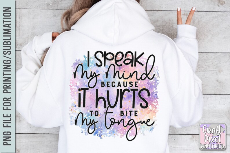 K&ouml;nnte beinhalten: Ein wei&szlig;er Hoodie mit einem bunten Aquarellhintergrund und dem Text "Ich sage meine Meinung, weil es weh tut, sich auf die Zunge zu bei&szlig;en".