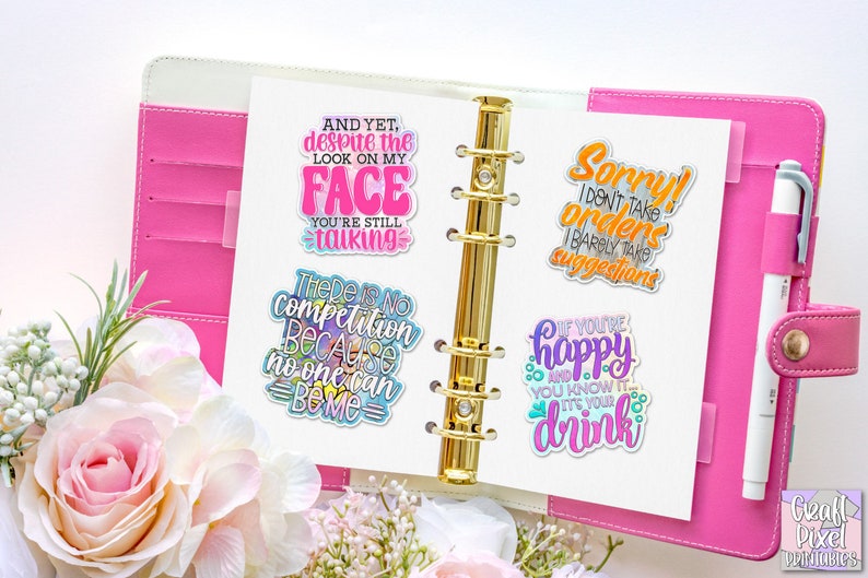 May include: Four colorful stickers with humorous sayings are displayed in a pink and white planner. The stickers feature the phrases "And yet, despite the look on my face you're still talking", "There is no competition because no one can be me", "Sorry! I don't take orders I barely take suggestions", and "If you're happy and you know it, drink it's your drink".