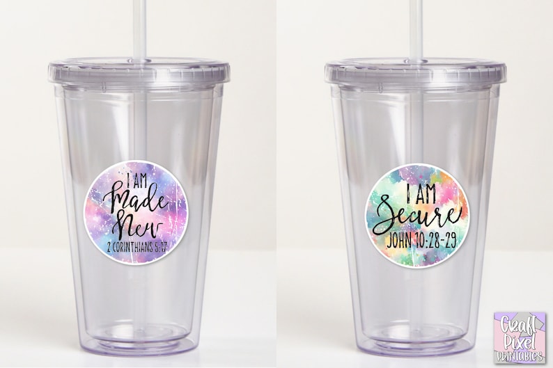 May include: Two clear plastic tumblers with lids and straws. The tumblers have colorful watercolor-style stickers with inspirational quotes and bible verses. The left tumbler has a sticker that says "I AM Made New 2 Corinthians 5:17". The right tumbler has a sticker that says "I AM Secure John 10:28-29".