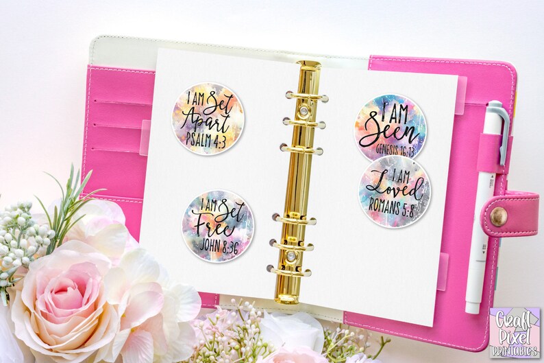 May include: Four colorful round stickers with inspirational messages and bible verses. The stickers feature watercolor-like backgrounds with a white outline. The text on the stickers reads: "I am Set Apart Psalm 4:3", "I am Set Free John 8:36", "I am Seen Genesis 16:13", and "I am Loved Romans 5:8".