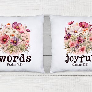 May include: Two white pillow covers with floral designs and inspirational quotes. The left pillow features a pink and white floral design with the words "words" and "Psalm 19:14". The right pillow features a pink and white floral design with the words "joyful" and "Romans 15:13".