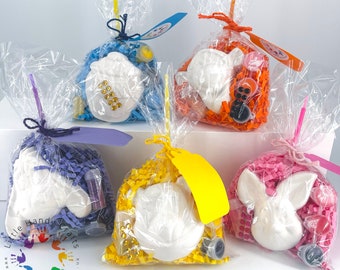 May include: Five clear plastic bags filled with colorful tissue paper and white ceramic animal figurines. Each bag includes paint, glitter, and other craft supplies. The bags are tied with string and have tags that say "Little Handy Crafts".