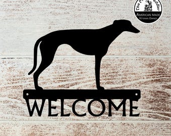 May include: Black metal silhouette of a Greyhound dog with the word "WELCOME" on a metal sign below. The sign has two holes for hanging. A small circle with the text "The Metal Peddler, American Made, Veteran Owned" is in the top right corner.