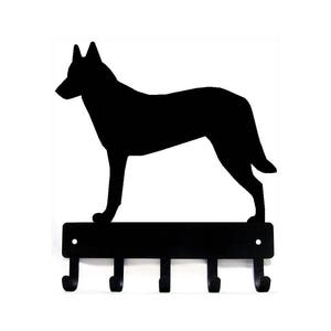May include: Black metal key holder with a silhouette of a dog standing on top. The key holder has five hooks.