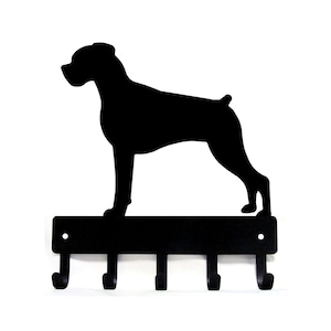 May include: Black metal key holder with a silhouette of a Boxer dog. The holder has five hooks.