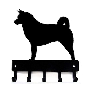 May include: Black metal key holder featuring a silhouette of a Finnish Lapphund dog. The holder has five hooks for hanging keys.
