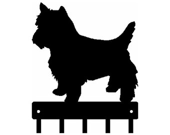 May include: Black metal key holder with a silhouette of a West Highland White Terrier dog standing on top. The key holder has five hooks.