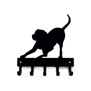 May include: Black metal key holder with a silhouette of a dog in a playful pose. The holder has five hooks.