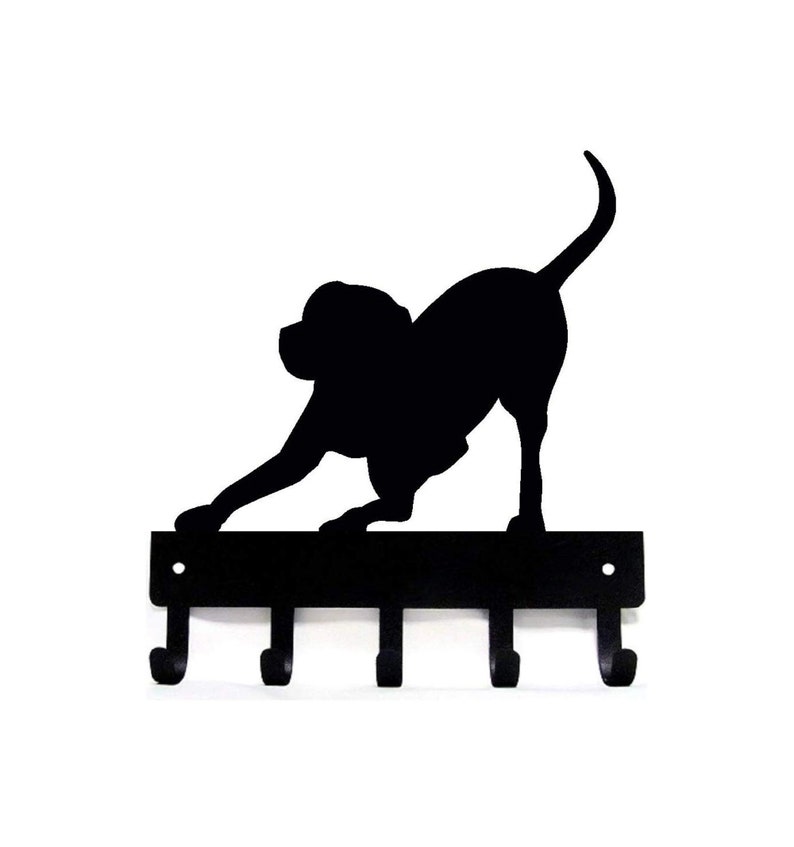 May include: Black metal key holder with a silhouette of a dog in a playful pose. The holder has five hooks.