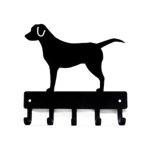 May include: Black metal key holder with a silhouette of a Labrador Retriever standing on top. The key holder has five hooks.