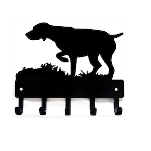 May include: Black metal key holder with a silhouette of a German Shorthaired Pointer dog in a hunting pose. The key holder has five hooks.