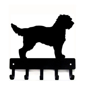 May include: Black metal key holder with a silhouette of a dog standing on top. The key holder has five hooks.