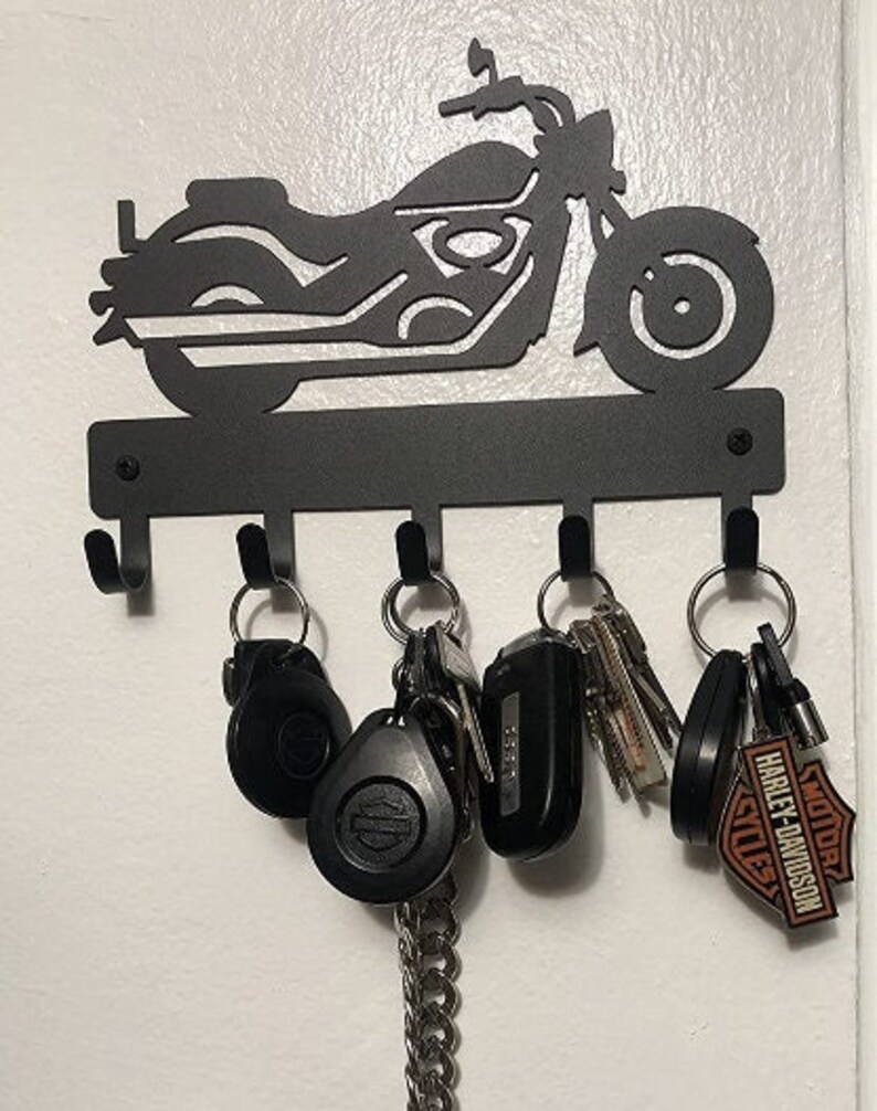 Black powder coated, five hook, metal key rack with the silhouette of a cruiser style motorcycle, the hooks hold multiple sets of keys.