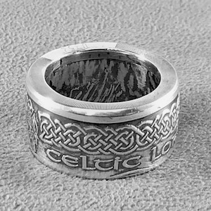 May include: A silver ring with a Celtic knot design and the words "Celtic Love" engraved around the band.