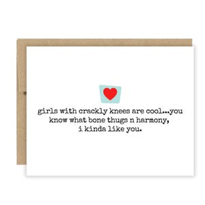 May include: A white greeting card with a brown envelope. The card features the text "girls with crackly knees are cool...you know what bone thugs n harmony, i kinda like you." A small blue square with a red heart is at the top.
