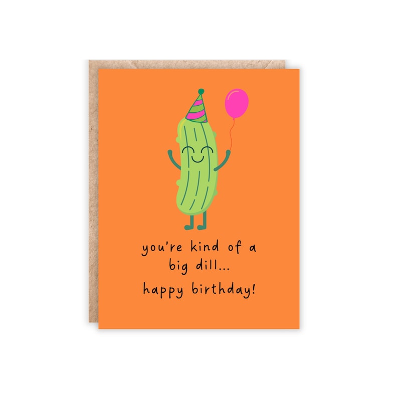 orange portrait size card. green pickle at the top with a silly face, holding a balloon and has a party hat on. text reads 'you're kind of a big dill...happy birthday