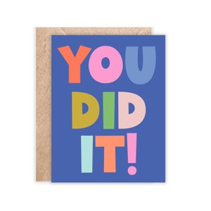 May include: A blue card with the text "YOU DID IT!" in colorful, playful letters. The card is perfect for celebrating a graduation, promotion, or any other achievement.