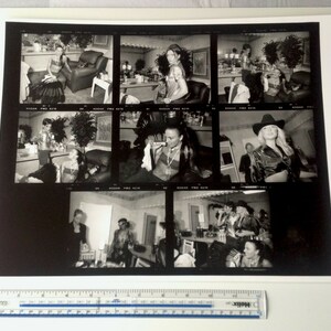 May include: A black and white photo contact sheet with nine images of people in various poses. The images are arranged in a 3x3 grid. The images are all taken in a studio setting and feature people in different outfits and poses.