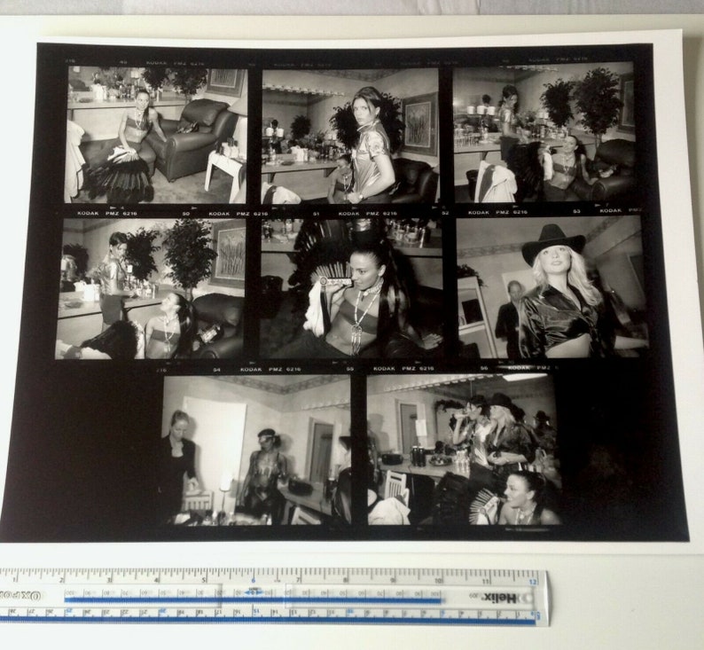May include: A black and white photo contact sheet with nine images of people in various poses. The images are arranged in a 3x3 grid. The images are all taken in a studio setting and feature people in different outfits and poses.