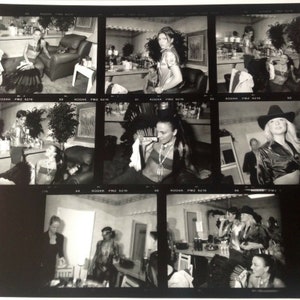 May include: A black and white photo contact sheet with multiple images of people in various poses. The images are arranged in a grid pattern and labeled with "Kodak PMZ 6210" and "Kodak PMZ 6216".
