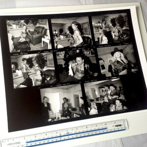May include: A black and white contact sheet of photographs showing a woman in various poses. The woman is wearing different outfits, including a dress, a jacket, and a shirt. The photos were taken in a studio setting.