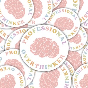 May include: A collection of white, round stickers with a pink brain graphic. The stickers have the words "PROFESSIONAL OVERTHINKER" in a rainbow of pastel colors. The brain graphic is also pink.