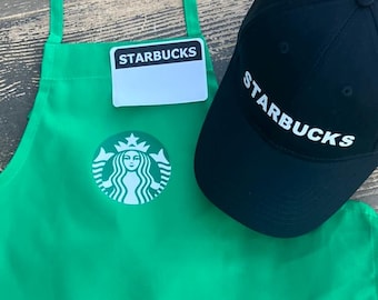 2 Color logo KIDS Starbucks Barista Apron. Purchase hat & apron together comes with 2 FREE name tags. Ages 12/18m, 2-4, 5-9. 10-13