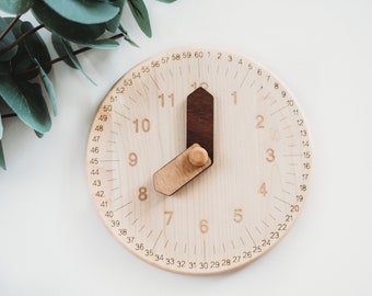 Wooden toy clock with minute and hour in different shades for easy learning