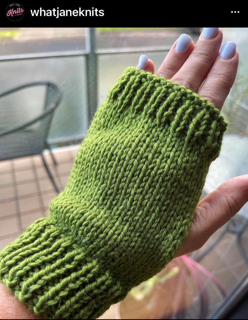 May include: A green knitted fingerless glove, showcasing a ribbed cuff and a textured stitch pattern. The glove is a vibrant shade of green, perfect for keeping hands warm while allowing finger movement. The item is handmade.
