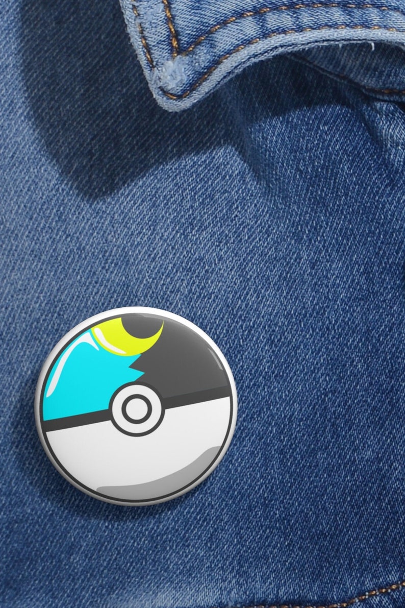 May include: A white and gray Poke Ball with a blue and yellow crescent moon design.