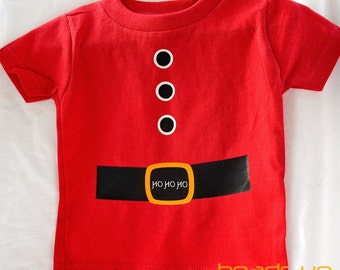 May include: Red short-sleeved t-shirt with a black belt and gold buckle. The belt has the text "HO HO HO" printed on it. There are three black buttons on the shirt.