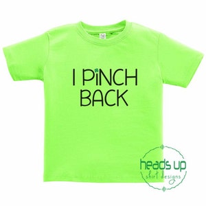 May include: A bright green t-shirt with the text "I *pinch* back" in black. A small shamrock is above the word "pinch".