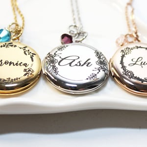 May include: Three gold, silver, and rose gold locket necklaces with floral designs and personalized names: Veronica, Ash, and Lucy.