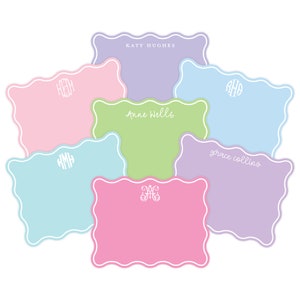 May include: A collection of seven scalloped-edge rectangular note cards in pastel shades of lavender, pink, light blue, and lime green. Each card features white printed text or monograms, including KATY HUGHES, Anne Wells, and grace collins.