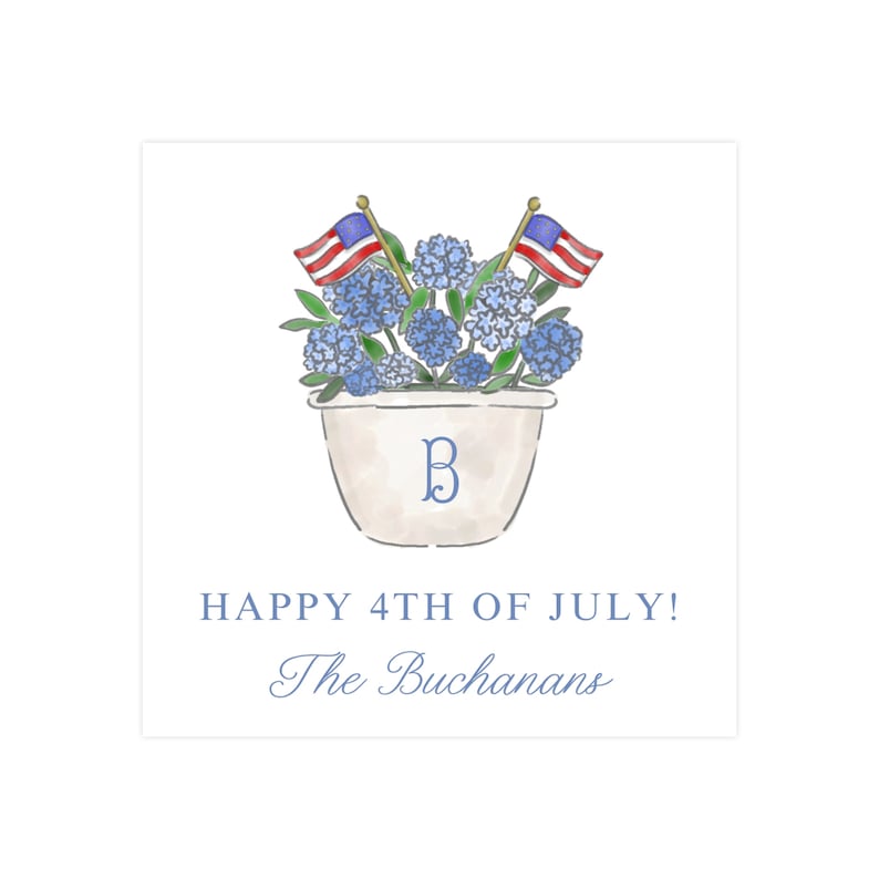 May include: A white planter with a blue "B" monogram is filled with blue hydrangeas and topped with two small American flags. The text "HAPPY 4TH OF JULY! The Buchansans" is below the planter.