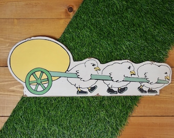 Chicks Pulling Egg Sign