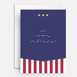 May include: A rectangular greeting card with a dark blue upper section featuring three yellow stars and white Morse code symbols. The lower section displays vertical red and white stripes. The card is positioned against a white envelope background.