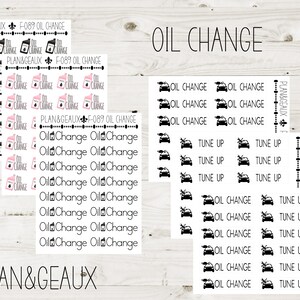 May include: A set of black and white stickers with car icons and the text "Oil Change" and "Tune Up". The stickers are on a white background with a woodgrain pattern.