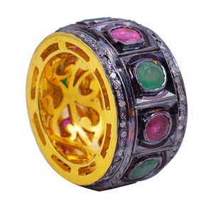 May include: A gold ring with a black band and green and red gemstones. The ring is set with small diamonds around the band.