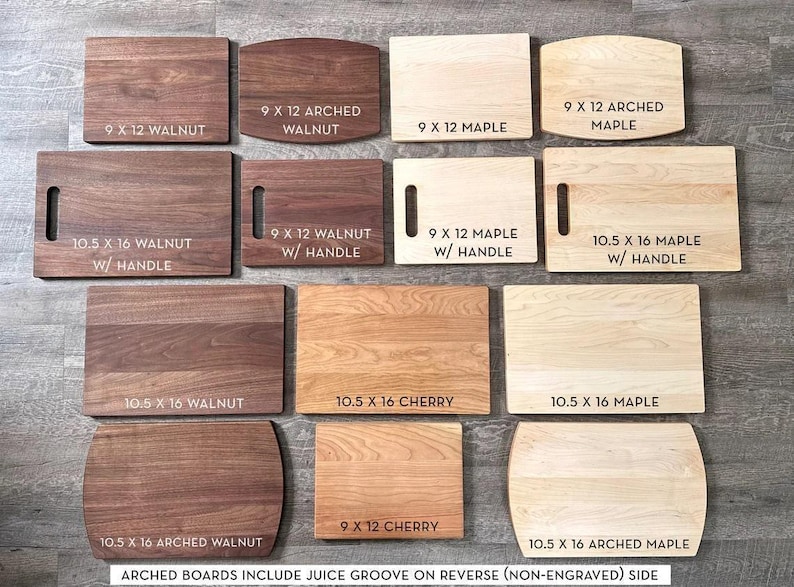 a collection of various wooden cutting boards, each with different sizes and shapes, arranged on a wooden surface.