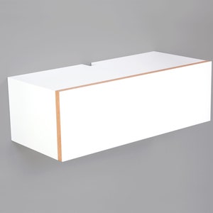 May include: White floating shelf with a wood trim around the edge. The shelf is mounted to a gray wall.