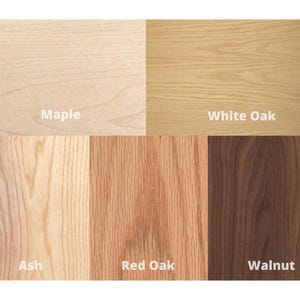 May include: Close-up of wood samples in different colors and grains. The samples are labeled "Maple", "White Oak", "Ash", "Red Oak", and "Walnut".