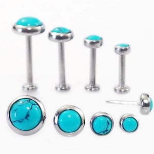May include: A set of six turquoise gemstone body jewelry pieces. The jewelry is made of surgical steel and features a round turquoise stone with a silver bezel setting. The jewelry is available in different sizes.