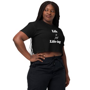 May include: A black cropped t-shirt with white text that reads "Life is just Life-ing".