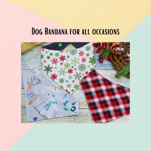 May include: Three dog bandanas on a wooden surface. One bandana is white with red and green snowflakes, another is gray with a winter scene, and the third is red and white plaid.