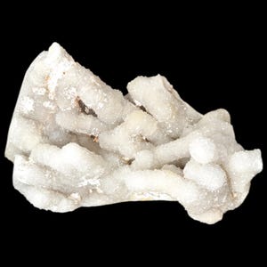 May include: A close-up of a white quartz cluster with a crystalline structure. The quartz has a rough, textured surface and is set against a black background. The cluster has a natural, organic shape.