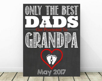 Puede incluir: Un letrero de pizarra negro y blanco con el texto "Only the best dads get promoted to grandpa" en texto blanco. Un corazón rojo con huellas blancas está en el centro del letrero. El texto "May 2017" está en la parte inferior del letrero.